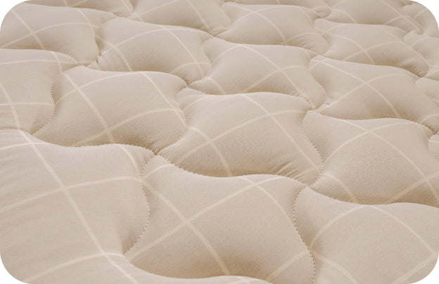 Cream-colored quilted mattress with a grid pattern and soft texture.