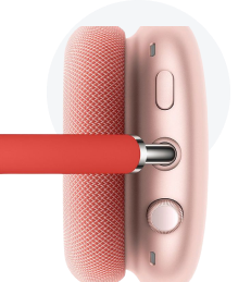 Rose gold wireless headphones with a textured finish and adjustable volume control knob.